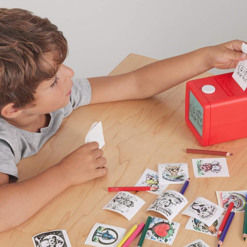 A child printing and coloring stickers at a craft table