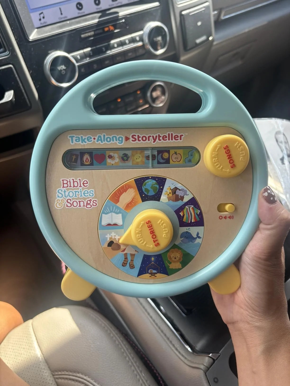 Customer holding the Bible story and song player