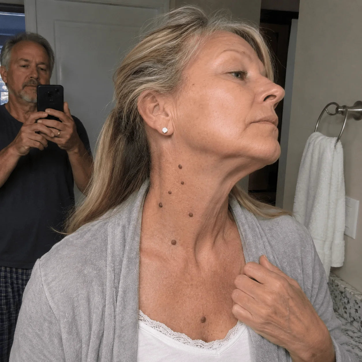 Mature woman showing raised-looking spots on her neck