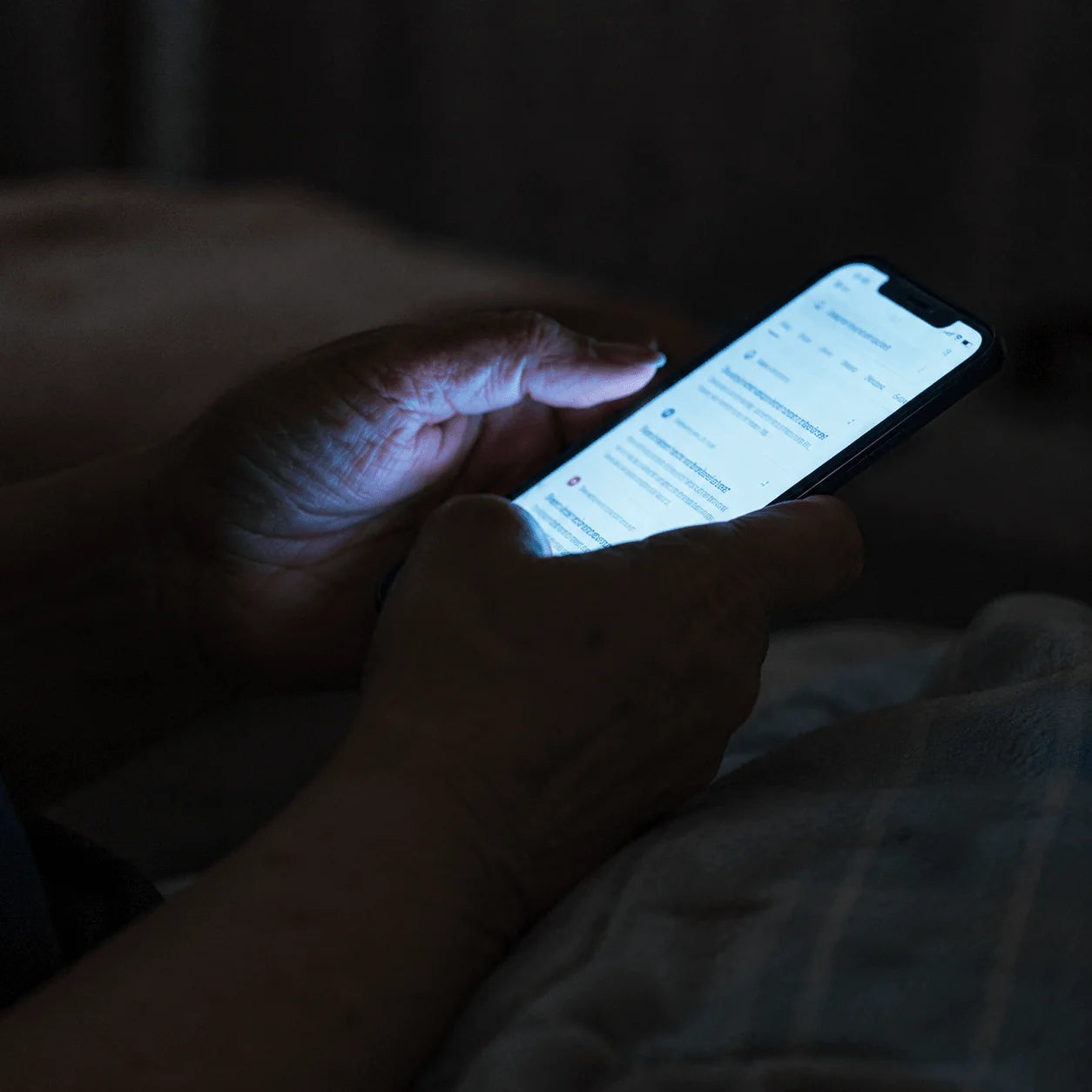 Person researching skin concerns on a phone at night